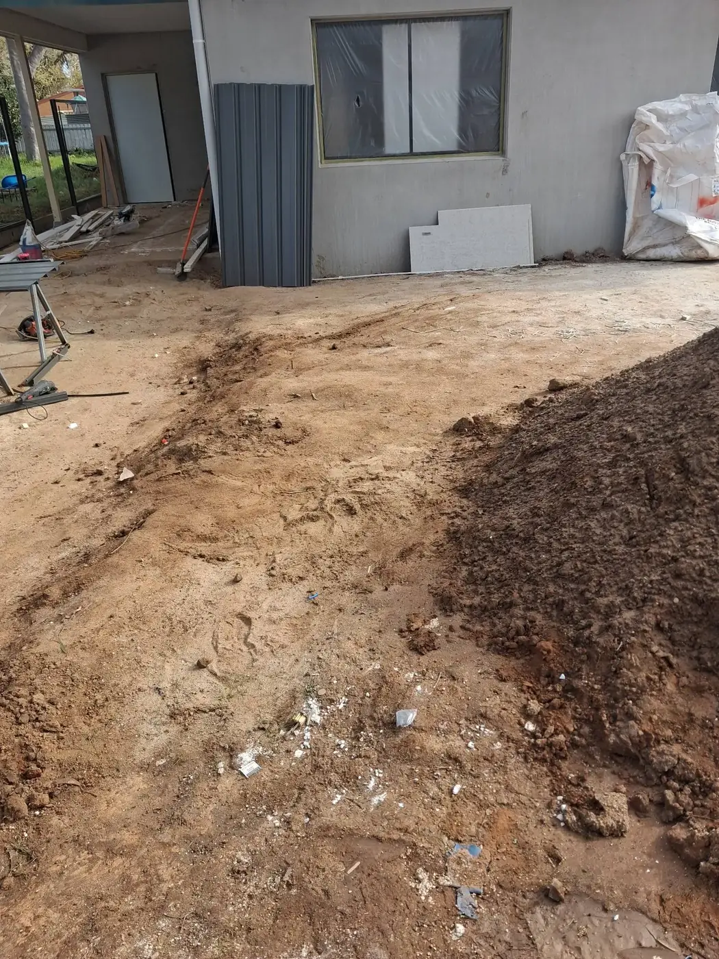 The same site with the debris cleared, leaving bare dirt
