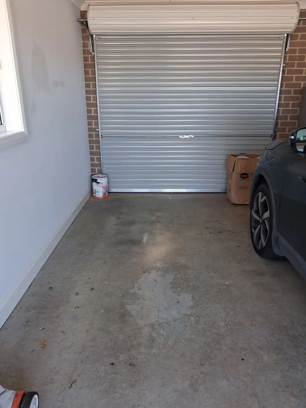The same garage emptied, with a car parked back inside